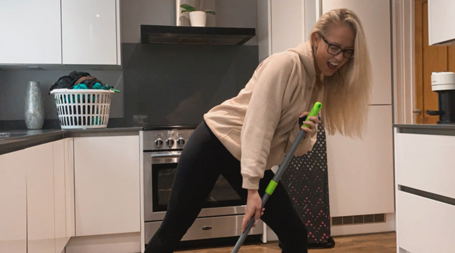 Hayley doing housework and singing into a broom